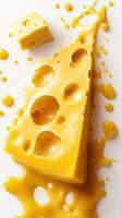 Melting yellow cheese drips and spills on a clean white surface showcasing texture and color photo