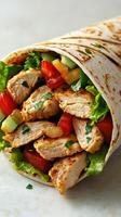 Grilled chicken wrap filled with fresh vegetables and herbs on display during lunchtime preparation photo