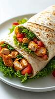 Delicious wrap filled with grilled chicken, fresh lettuce, and tomatoes served on a white plate photo