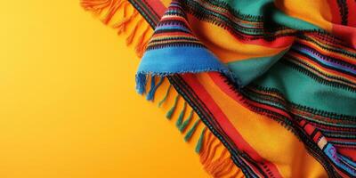 Vibrant pattern of a colorful woven blanket on a bright yellow background highlighting craftsmanship and textile design photo