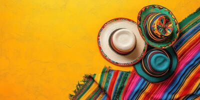 Colorful traditional hats on vibrant textile background with warm yellow tones photo