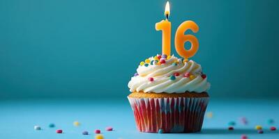 Celebrating a sweet sixteen birthday with a colorful cupcake topped with frosting and a candle photo