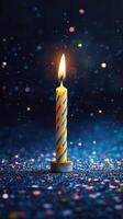 Colorful candle burns brightly amid sparkling confetti at a festive celebration in the evening photo