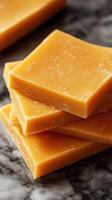 Natural honey soap bars stacked on a marble surface in a soft light setting photo