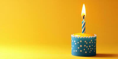 Birthday cupcake with a lit candle on a vibrant yellow background for celebration photo