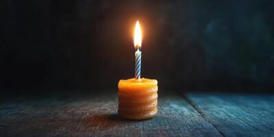 Candle glows softly in a dark room creating a warm intimate atmosphere during a quiet evening photo