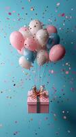 Colorful balloons and a gift box float against a blue background in a festive atmosphere photo