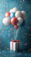 Colorful balloons soar above a gift box, creating a festive atmosphere for celebration photo