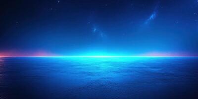 Vibrant twilight horizon over calm ocean with deep blue and purple hues illuminating the sky photo