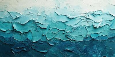 Textured abstract artwork featuring shades of blue and green created through layered techniques in an artist's studio photo