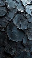 Unique textured surface formed by cracked dark rock layers in a natural environment photo