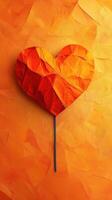 Creative paper art piece depicting a heart made of orange folds on a warm orange background, showcasing vibrant color and texture photo