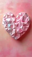 Colorful paper heart sculpture displayed against a soft pink abstract background showcasing artistic craftsmanship and creativity photo