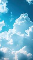 Beautiful fluffy clouds in a bright blue sky during midday with sunlight filtering through photo