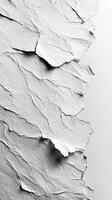 Torn white paper texture with intricate patterns and shadows on a light background photo