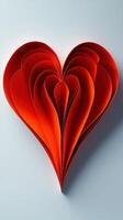 Colorful layered red heart design made from paper on a plain background showing creativity and craft photo