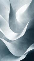 Abstract waves of pale, textured paper create a serene and fluid composition in soft shades of gray and white photo