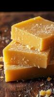 Natural handmade soap bars stacked on a wooden surface with a rustic background photo