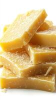 Natural beeswax blocks stacked neatly on a white background photo