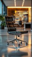 Black executive chair in a modern office interior design during daylight hours photo