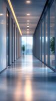 Long and modern hallway with large glass windows and soft lighting during late afternoon in a contemporary building photo