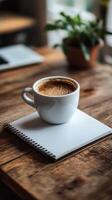Warm cup of coffee placed on a spiral notepad in a cozy cafe during the morning hours photo