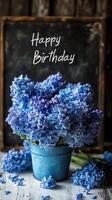Beautiful blue hyacinth flowers in a rustic pot wishing happy birthday in cozy indoor setting photo