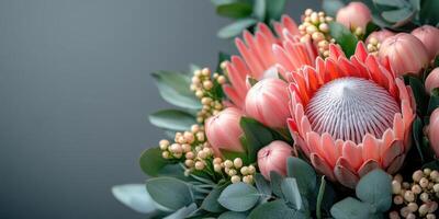 Beautiful colorful bouquet featuring protea flowers and lush greenery arranged artfully on a neutral background photo