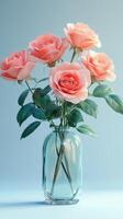 Beautiful pink roses arranged in a clear glass vase against a soft blue background photo