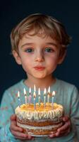 Young child celebrates birthday with cake and candles in cozy indoor setting at evening photo