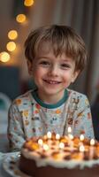 Young boy celebrates birthday with a joyful smile in cozy indoor setting full of lights photo