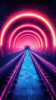 Bright neon lights illuminate an underground tunnel with railway tracks leading into darkness photo