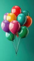 Colorful balloons floating against a turquoise background, creating a festive atmosphere for celebrations or events photo