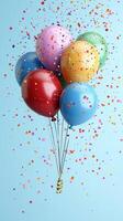 Colorful balloons floating amidst confetti create a festive atmosphere for celebrations or parties photo