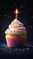 Deliciously decorated cupcake with colorful sprinkles and a lit candle on top celebrating a special occasion photo