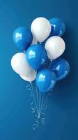Colorful collection of blue and white balloons floating against a deep blue background photo
