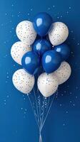 Colorful balloons with blue and white design create festive atmosphere against a solid backdrop photo