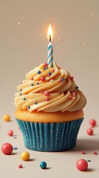 Colorful cupcake with a lit candle surrounded by sprinkles and candy balls in a festive setting photo