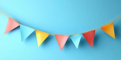 Colorful triangular bunting decorates a bright blue background for a festive celebration or party atmosphere photo