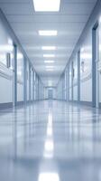 Long narrow corridor in a modern hospital lit with bright overhead lights at daytime providing a sterile environment photo