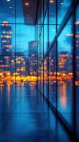 Urban skyline reflection captured during twilight in a modern building's corridor photo