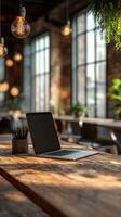 Cozy workspace featuring a laptop on a wooden table in a well-lit modern interior with plants and hanging lights photo