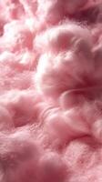 Soft and fluffy pink cotton clouds create a whimsical texture resembling cotton candy during daylight photo