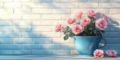 Elegant pink roses arranged in a blue container against a textured light-colored wall in a softly lit environment photo