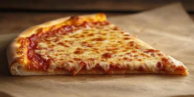 Classic cheese pizza slice lying on a wooden surface with a rustic feel photo