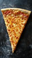 Delicious cheese pizza slice on a dark surface, perfect for a snack or meal any time of day photo