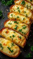 Delicious cheesy garlic bread served on a dark countertop with fresh parsley garnish photo