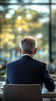 Business meeting taking place in a modern office with a view of nature in the background during daytime hours photo