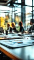 Business meeting in modern office space with charts and graphs displayed on table photo