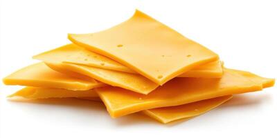Slices of yellow cheese stacked on a white surface ready for use in various dishes photo